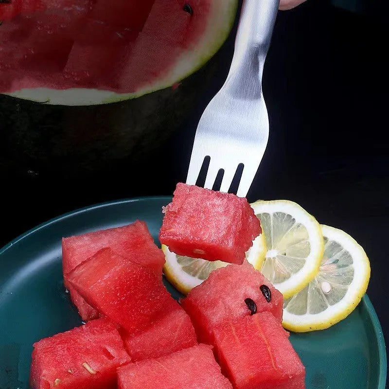 Silver stainless steel watermelon slicer and serving fork on a kitchen counter