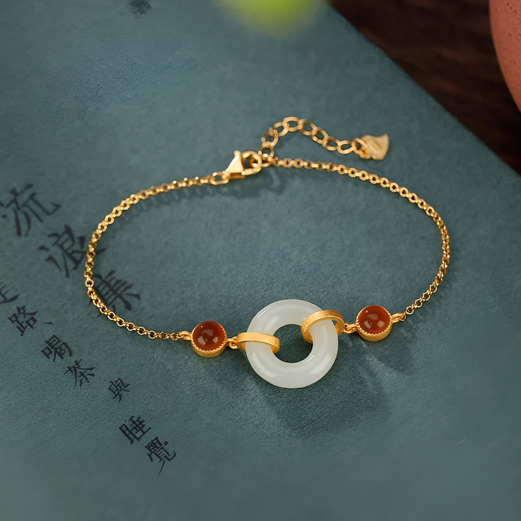 Gold-plated S925 sterling silver bracelet with inlaid natural Hetian jade stone and adjustable peace buckle clasp.