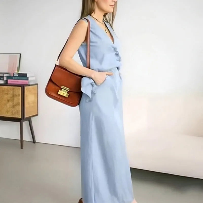 Women's white polyester two-piece set with sleeveless vest and long skirt on a hanger