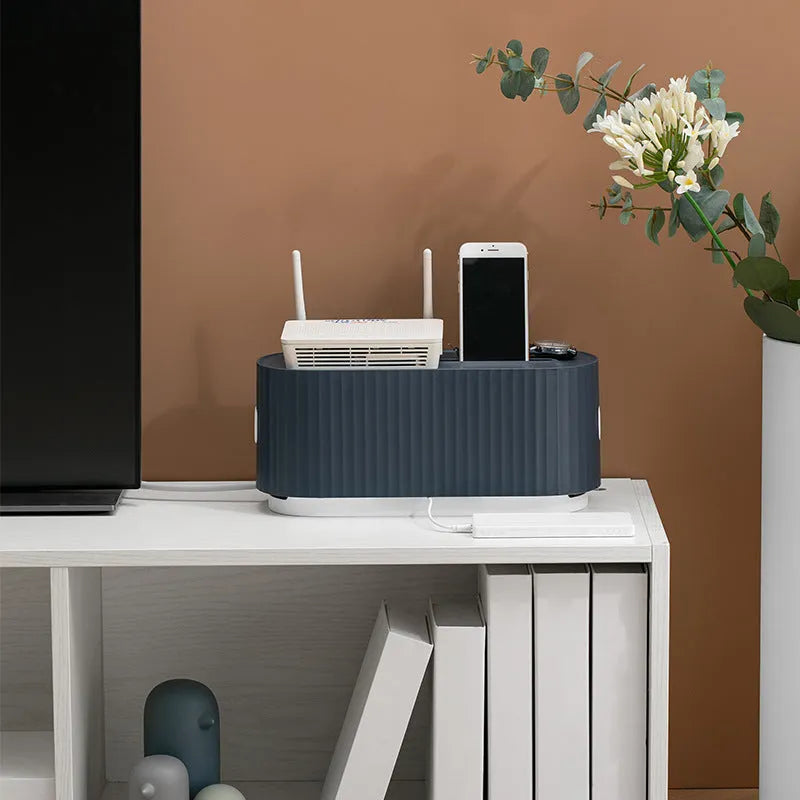 Blue and white HIPS plastic power strip storage box with lid open, showing cable holes and interior space.