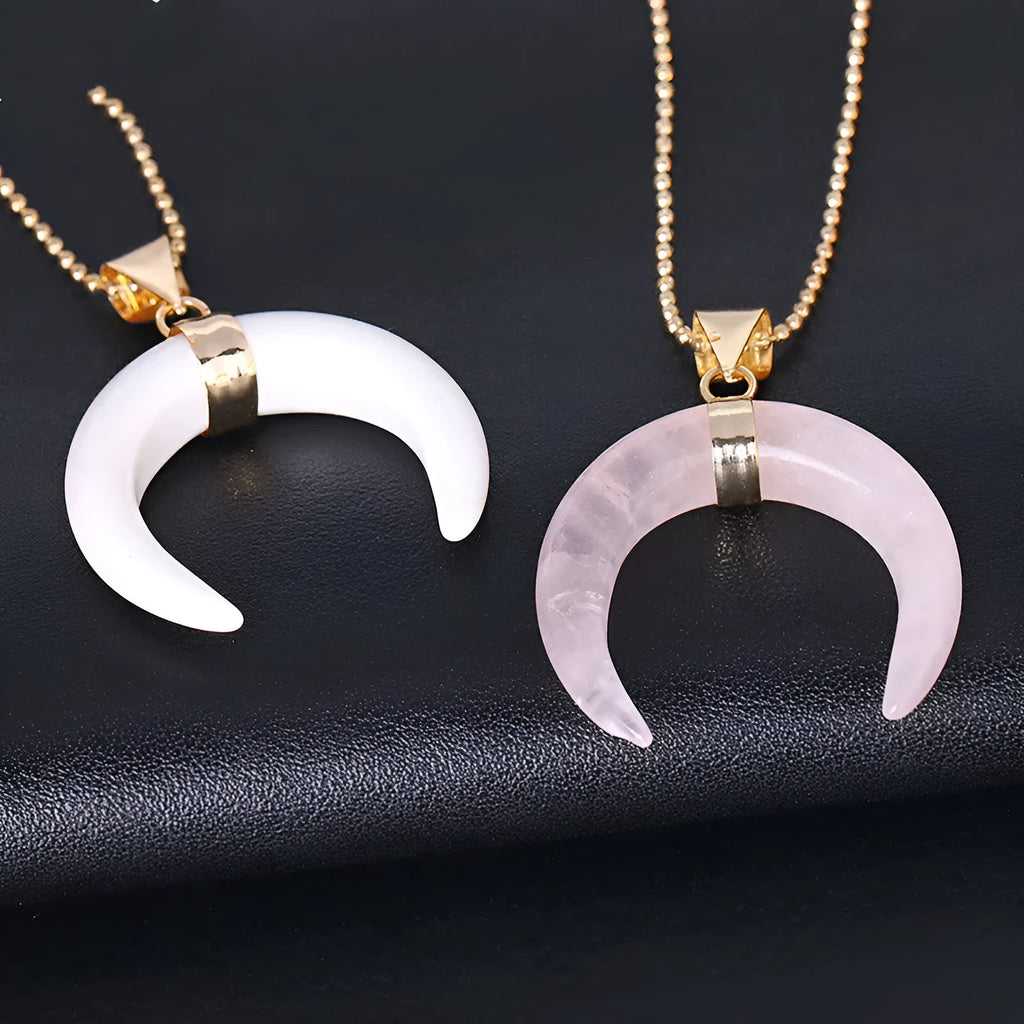 Close-up of an adjustable moon pendant necklace with a natural purple stone on a copper chain.