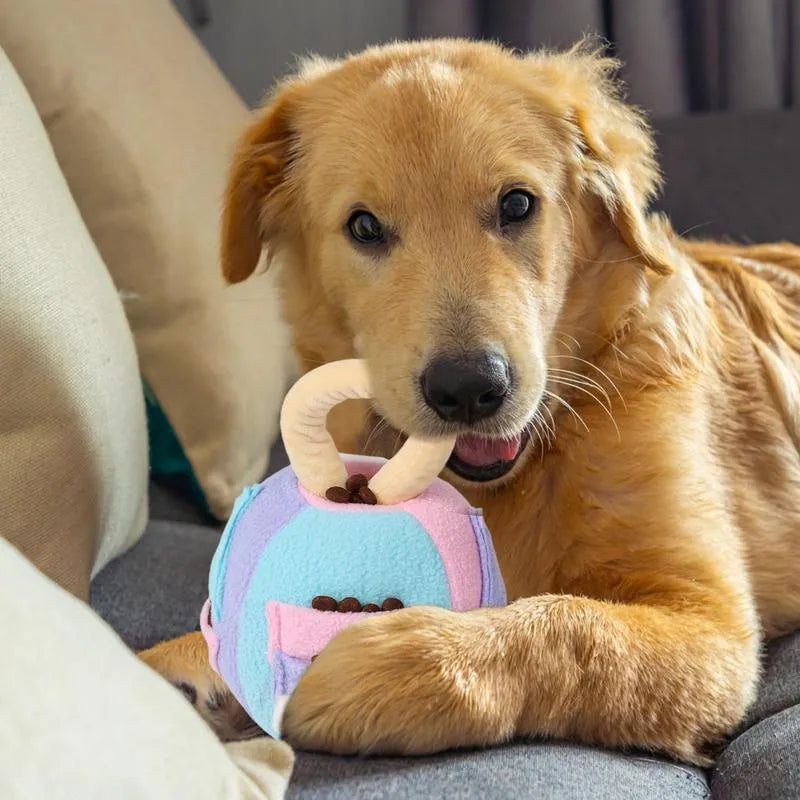 Green and pink plush squeaky ball dog toy with treat pockets measuring 12x12x18 cm