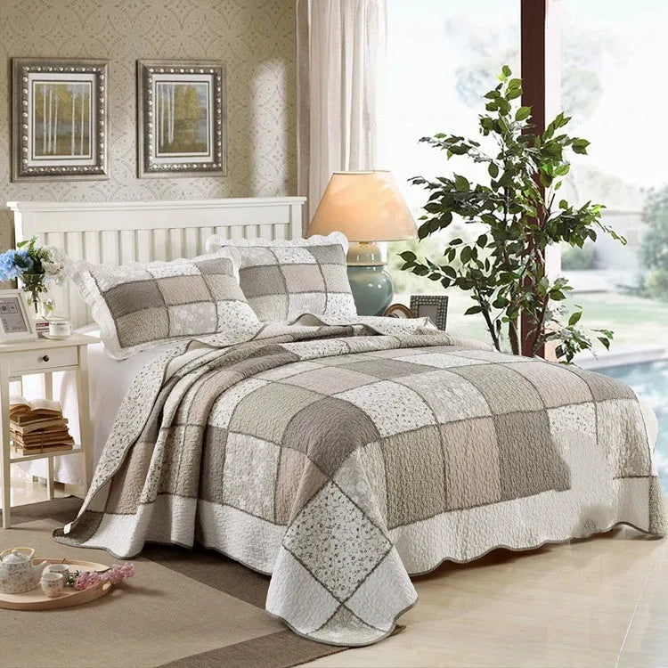 Washed pure cotton quilted bedspread and matching pillowcases set on a bed, shown in a beige colour option.