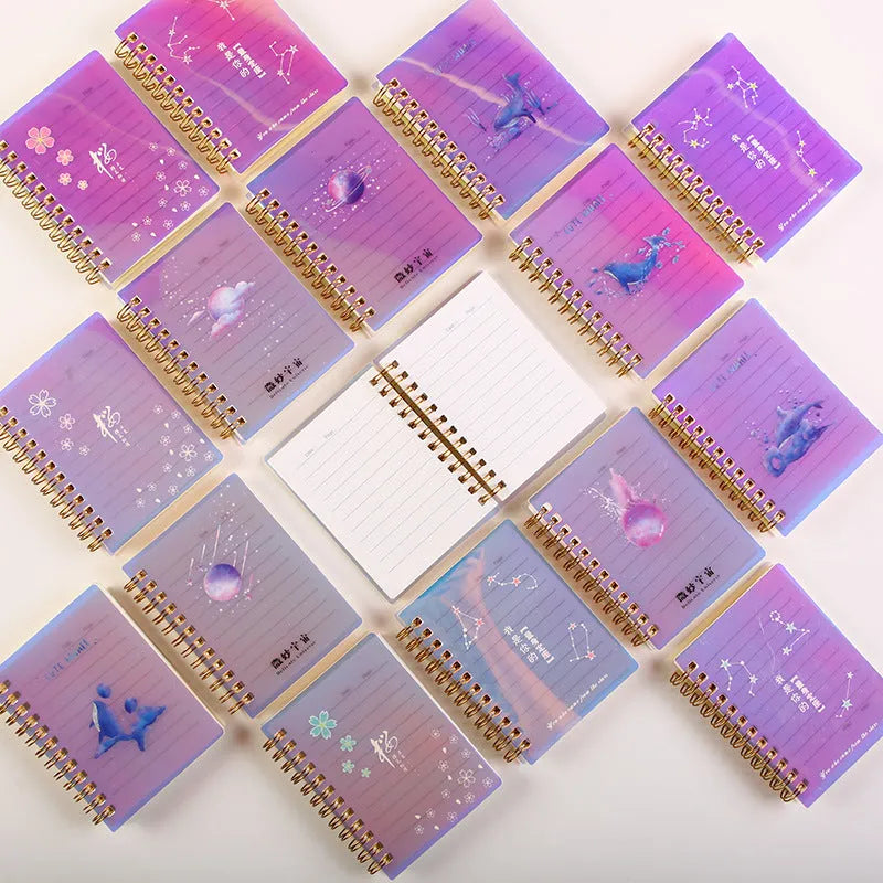 A7 rollover coil pocket notebook with decorative cover, shown with cover folded back to reveal spiral binding and inner pages.