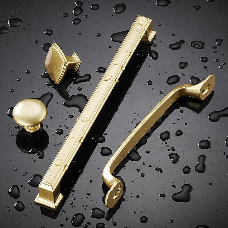Gold aluminium alloy T-shaped open cover cabinet door handle for single hole mounting.