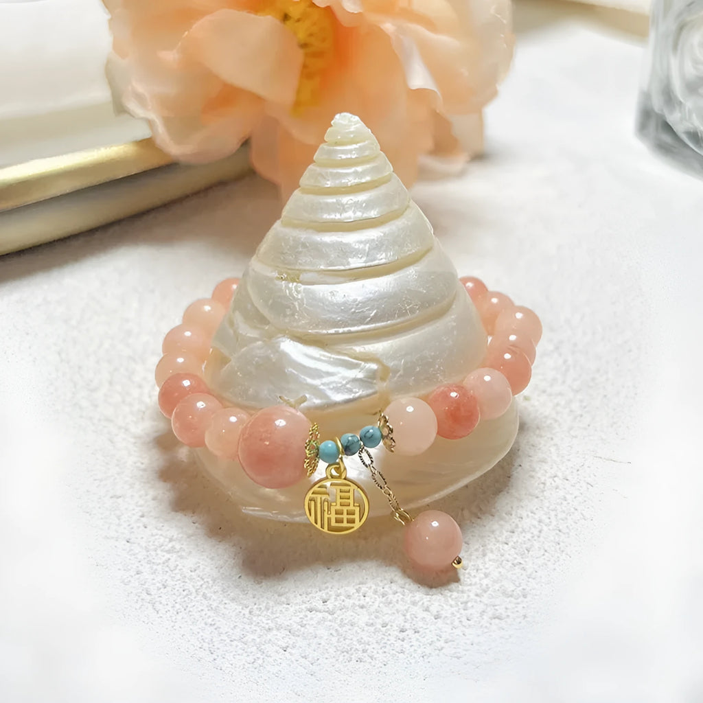 Pink natural stone set on a simple alloy chain bracelet for women.