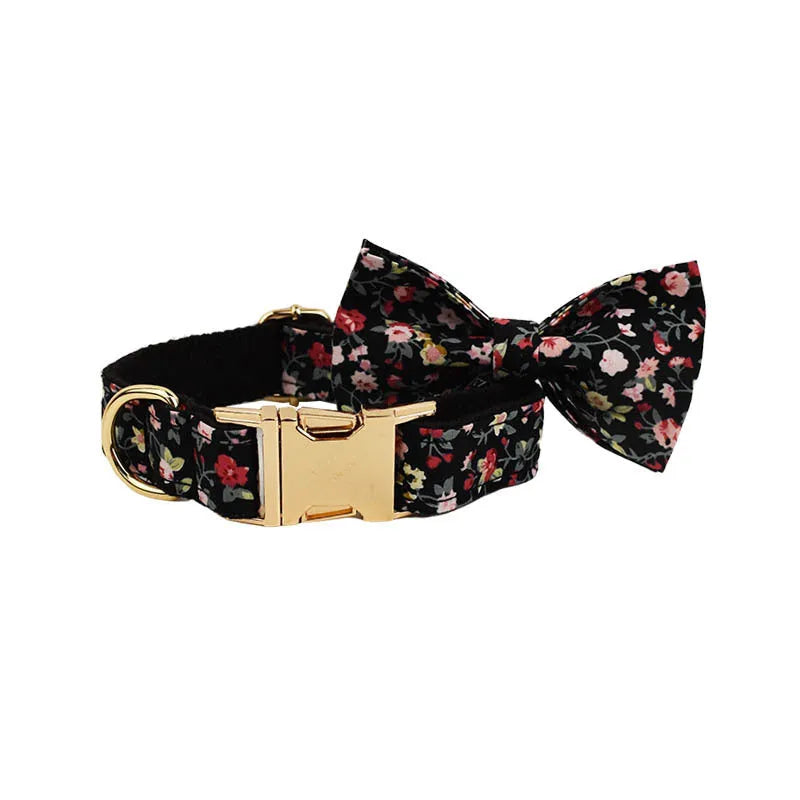 A cloth dog collar set with a removable bow, matching leash, and vest, featuring printed lettering.