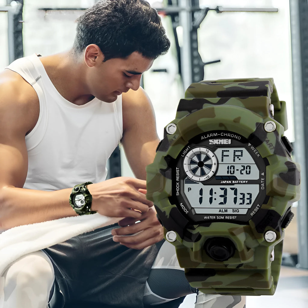 Electronic sports watch with round dial and plastic strap in camouflage green colour, showing GMT and 24-hour displays