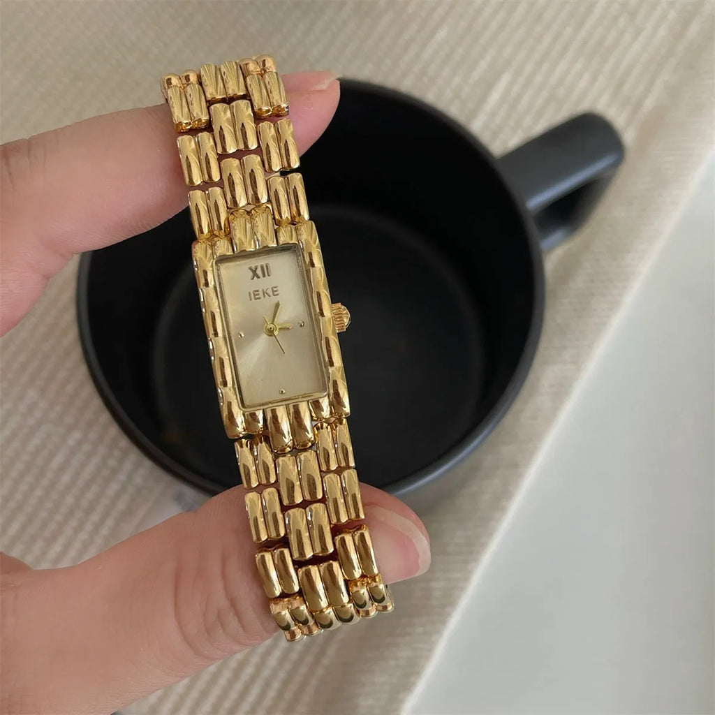 Women's mid-ancient bracelet watch with a 15mm silver dial and stainless steel strap.