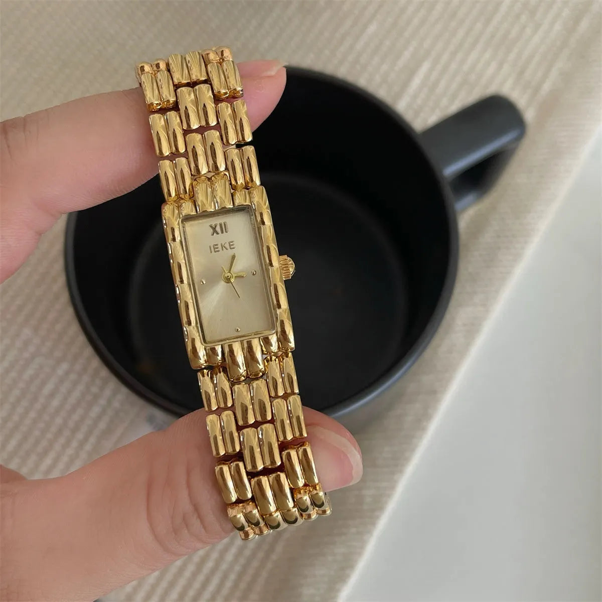 Women's mid-ancient bracelet watch with a 15mm silver dial and stainless steel strap.
