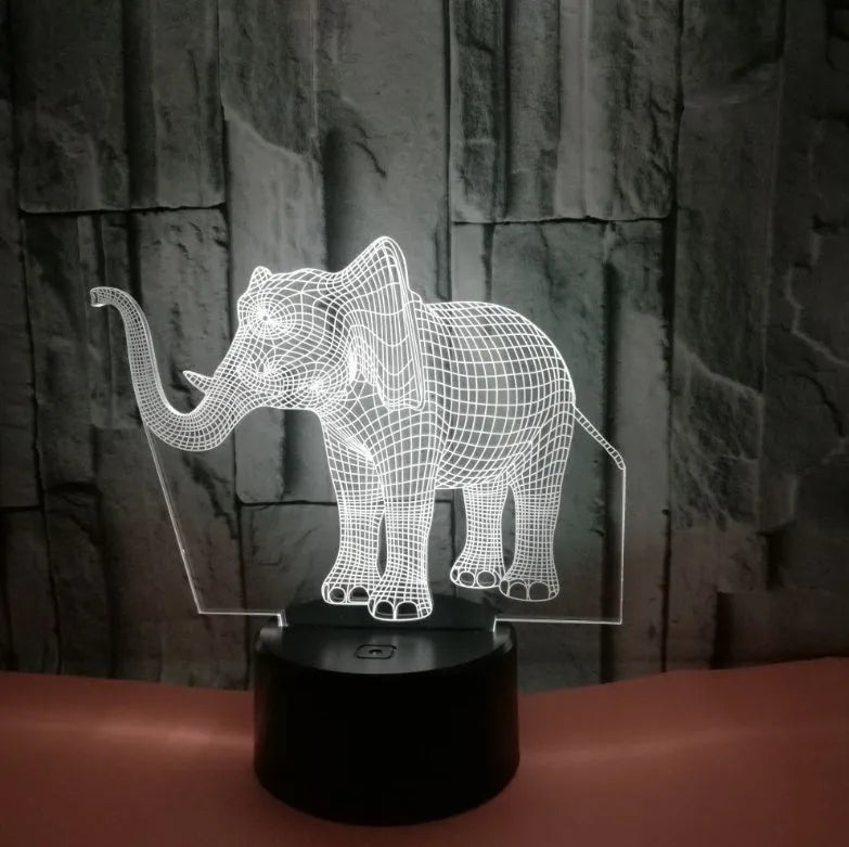 3D LED elephant touch lamp showing seven colour modes on a wooden desk