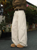 Men's straight-leg pleated trousers in black, brown, and apricot colours with mid-waist design