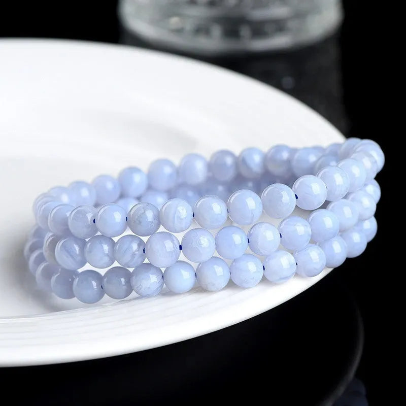 Natural blue agate bracelet with multi-circle pattern and a Ruyi charm.