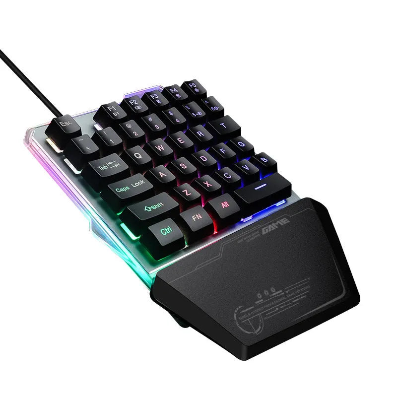 Black one-handed mechanical gaming keyboard with RGB backlit keys on a desk.