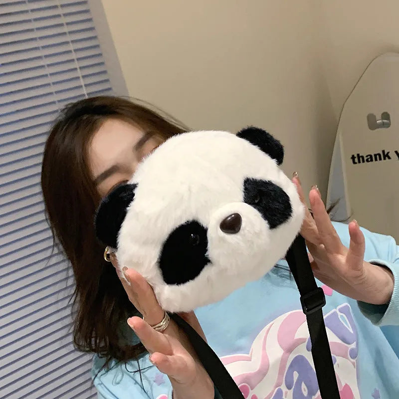 Soft plush cylindrical crossbody bag in panda head design with a sandwich pocket.
