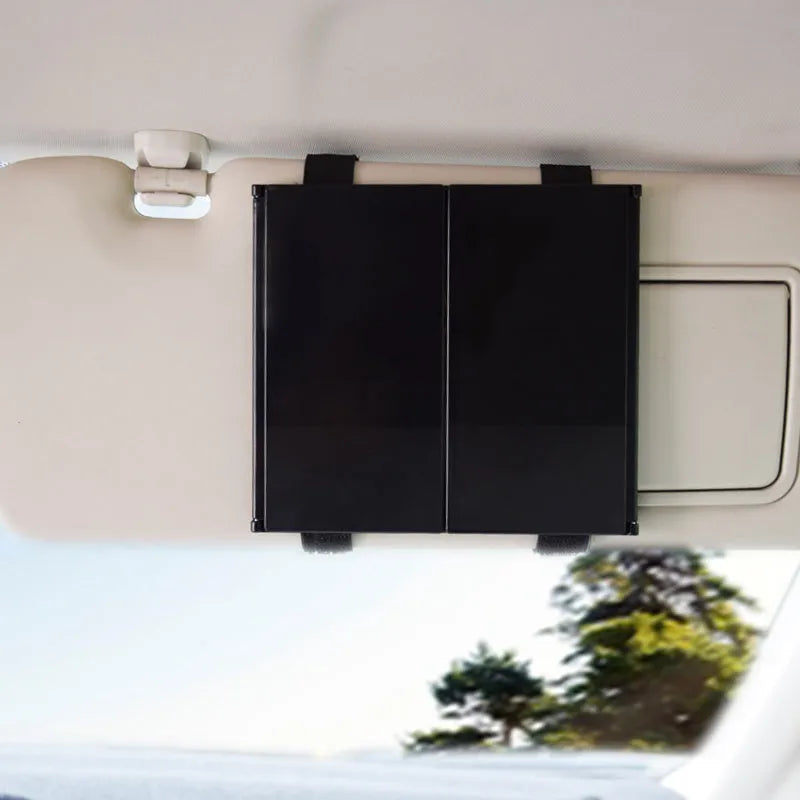 Silver portable folding car mirror shown both closed and open to double its length.