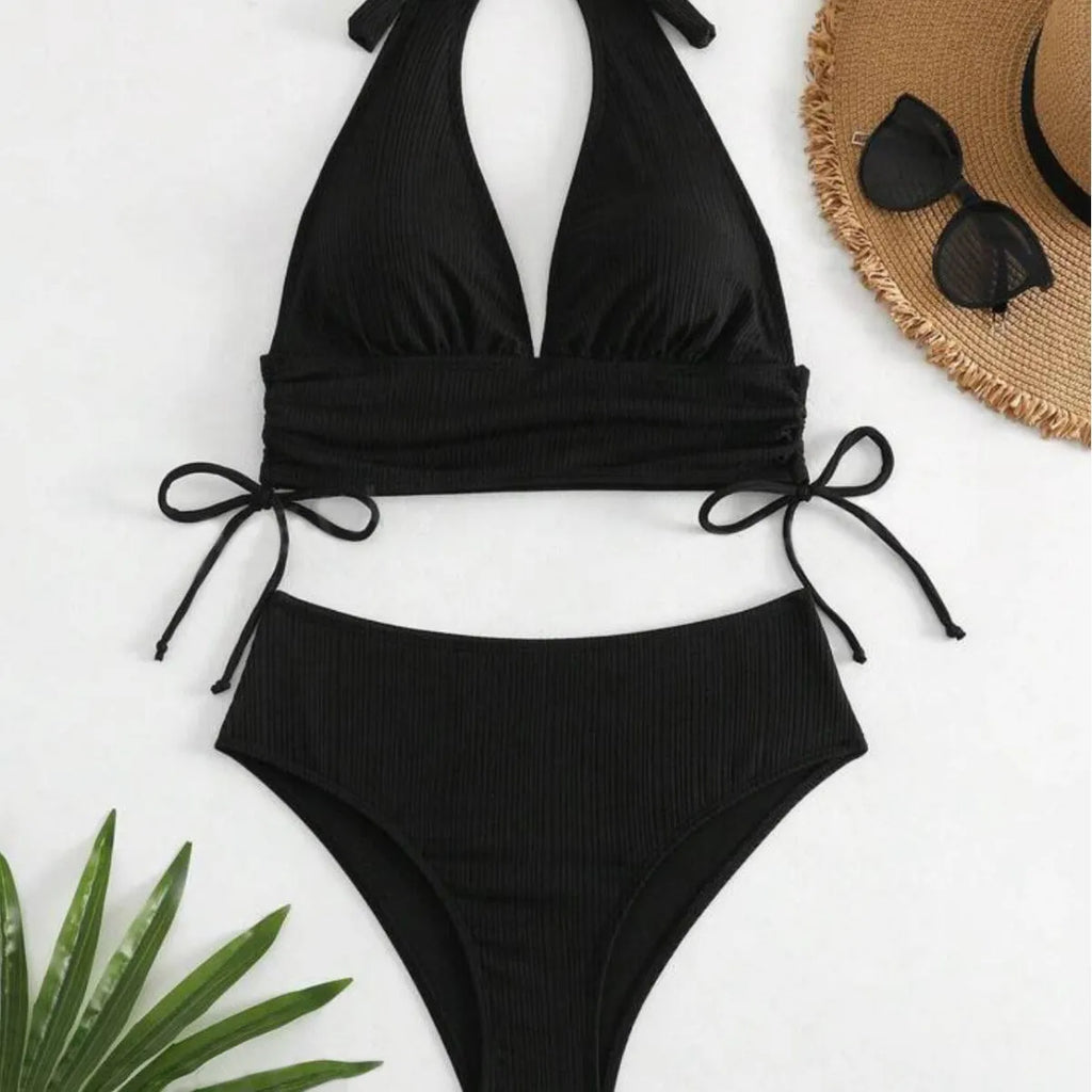 Women's black lace-up halter bikini set with brief bottoms on mannequin
