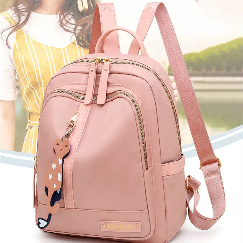 Men's black casual nylon backpack with shoulder straps, showing outer pocket and square vertical shape.