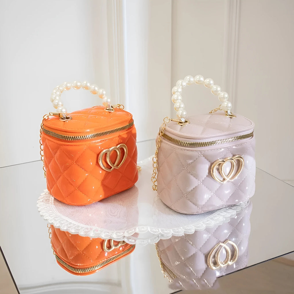 Women's PVC bucket gel bag with heart-shaped pattern in assorted colours.