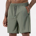 Man wearing black ice silk sport shorts with a high waist and cropped length.