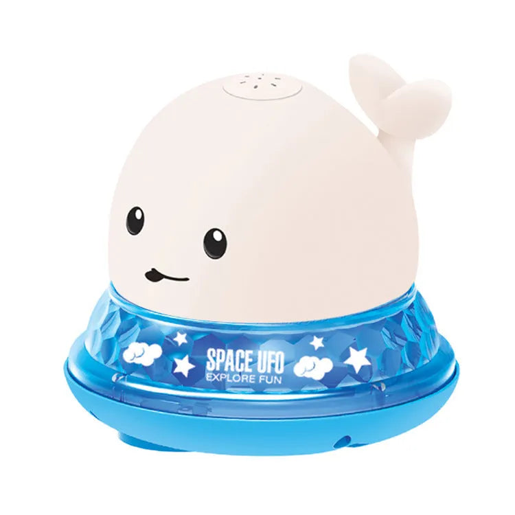 White and blue electric whale bath toy spraying water with flashing lights on a bathroom surface.