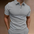 Men's gray loose fit cotton blend t-shirt with short sleeves and a button detail.