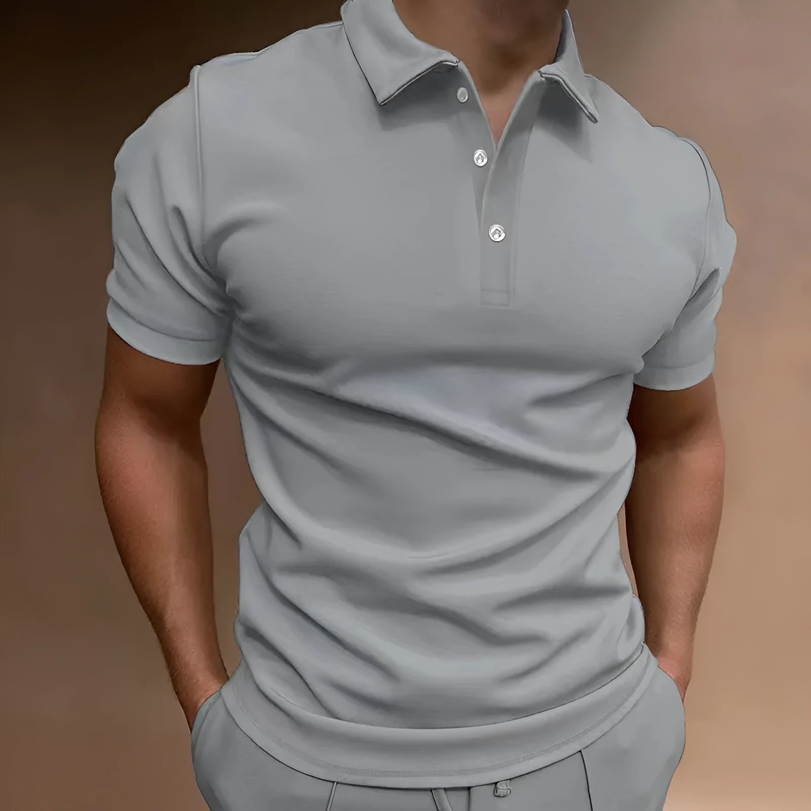 Men's gray loose fit cotton blend t-shirt with short sleeves and a button detail.
