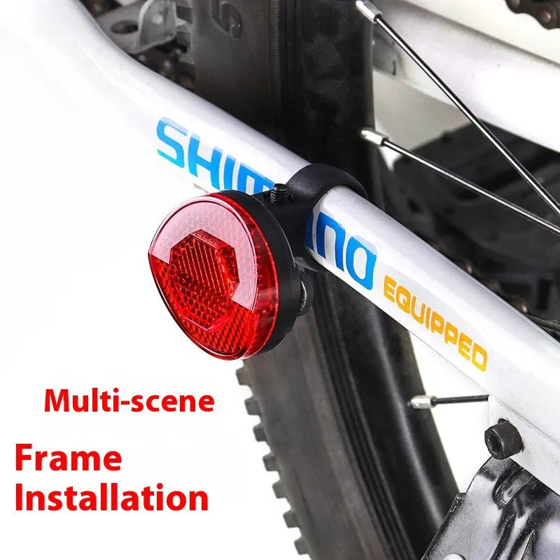 Red plastic bicycle taillight bracket mounted on seat post with reflective elements
