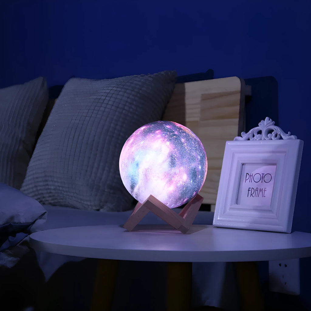 White 3D printed moon-shaped night light on a dark surface, demonstrating its textured surface and soft LED glow.