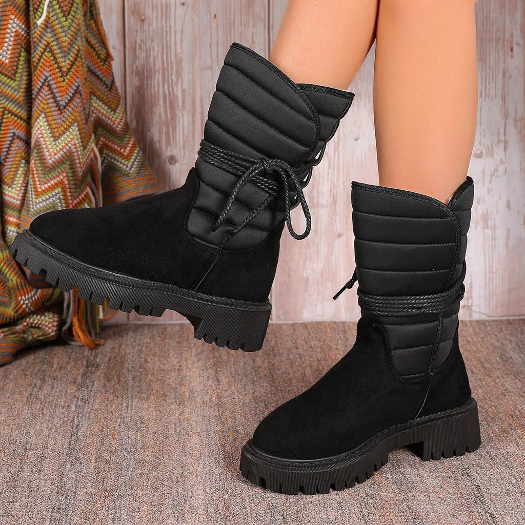 Women's black suede chunky heel mid-calf snow boot with lace-up front and fleece lining.