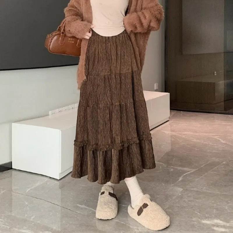 Women's beige corduroy A-line midi skirt with an elasticated waistband on a hanger.