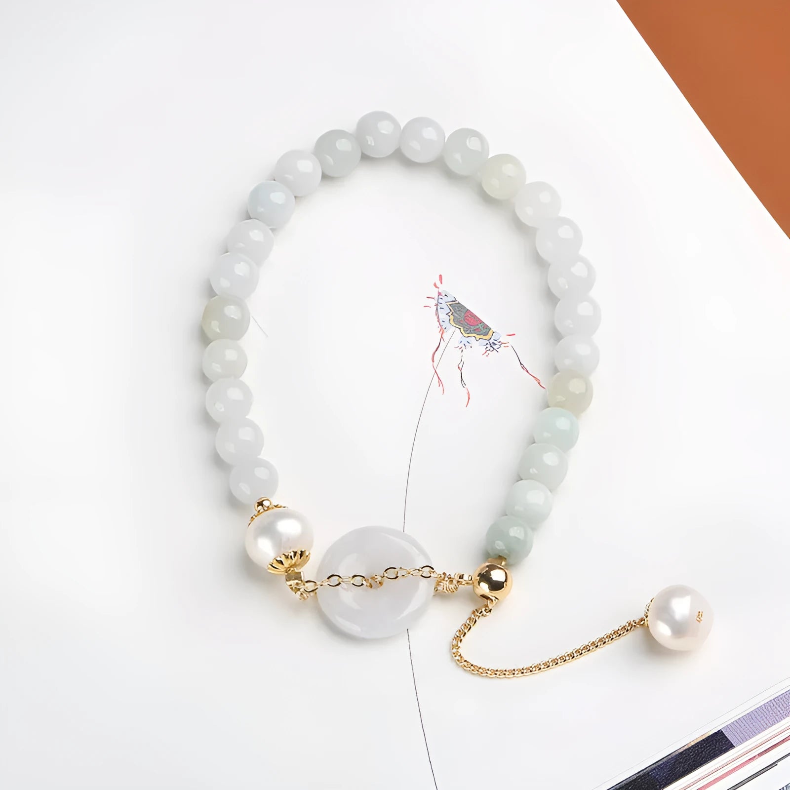 Natural emerald jade pearl bracelet with peace symbol buckle showing geometric charm arrangement
