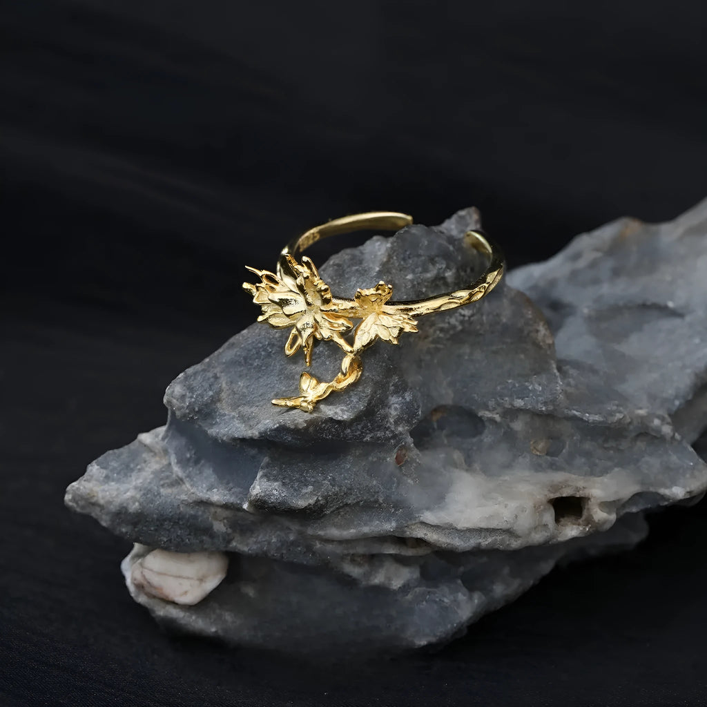 Silver butterfly ring with adjustable opening in white gold or gold finish.