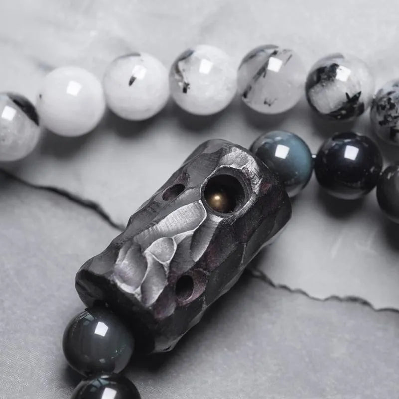 Ethnic black hair bracelet with white crystal tassel showing bending and lacing construction