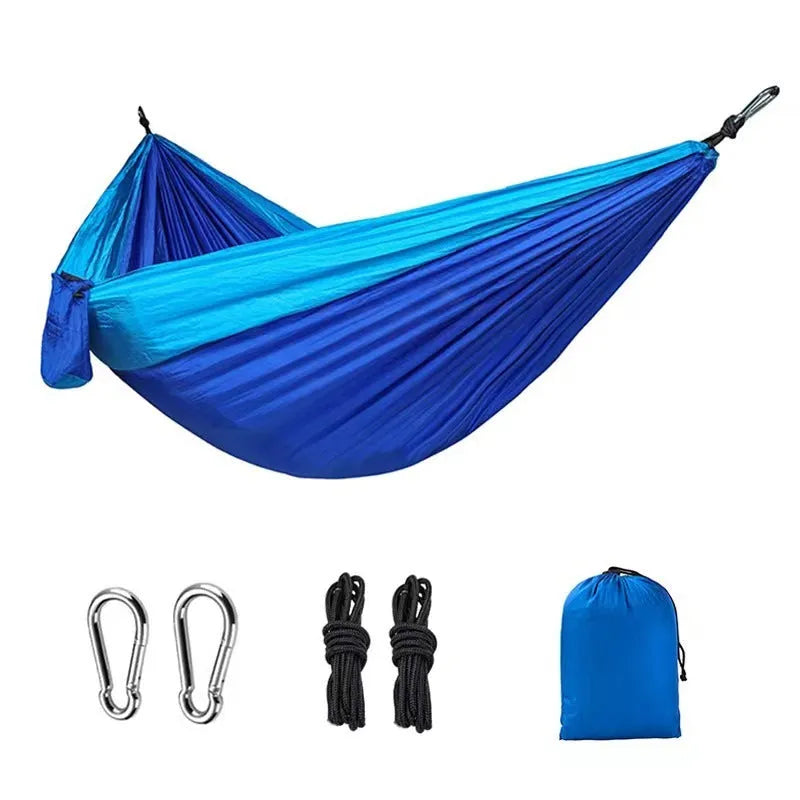 Blue nylon parachute cloth camping hammock hung between trees.