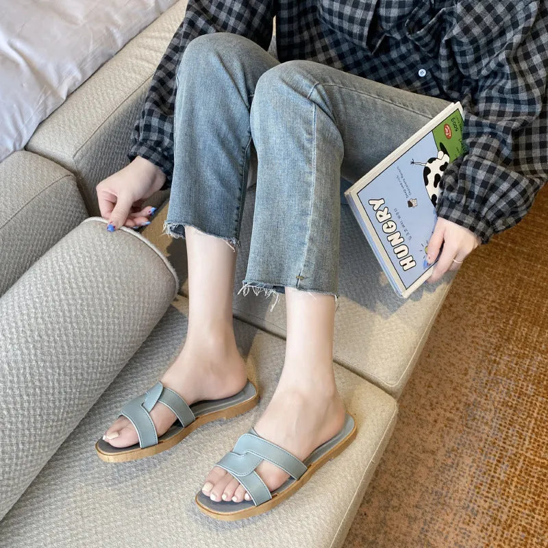 Women's PVC cross strap toe ring slipper in solid colour on a plain background.