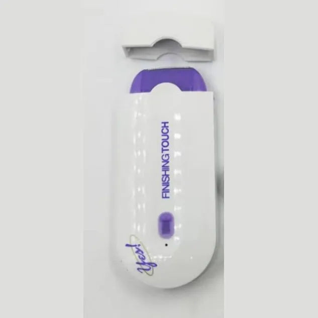 White rechargeable electric hair removal instrument with foil head and cleaning brush on a table.
