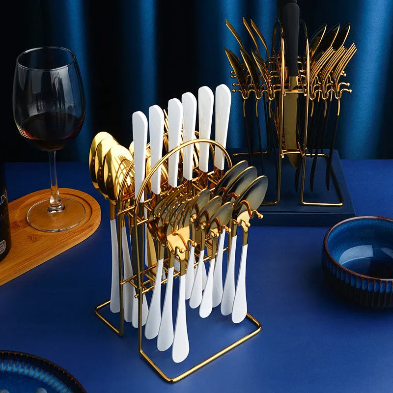 Gold 24-piece stainless steel cutlery set with knives, forks, spoons, and a storage rack.