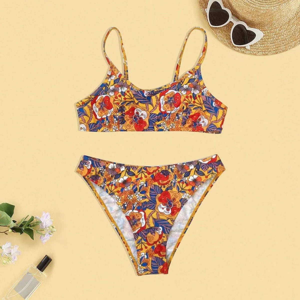 Plus size women's floral print strap bikini swimsuit two-piece set on a mannequin