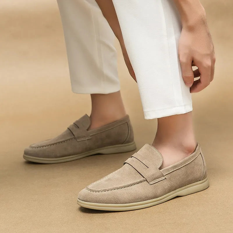 Men's beige leather slip-on casual shoes with a round toe and rubber sole.