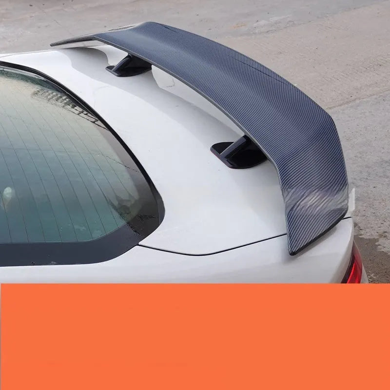 Universal punch-free car spoiler tail wing in ABS plastic on a vehicle.