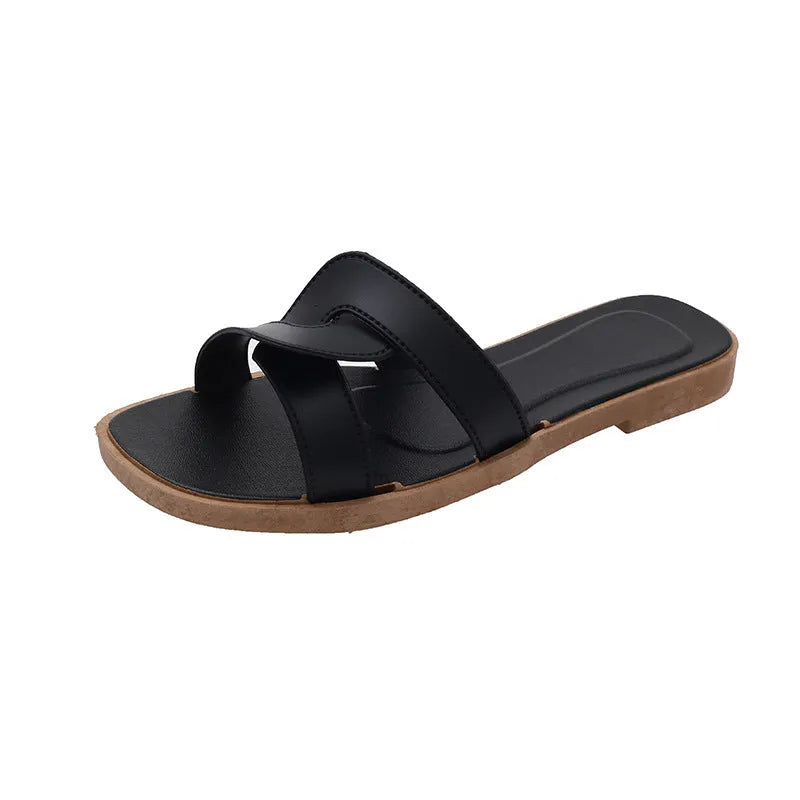 Women's PVC cross strap toe ring slipper in solid colour on a plain background.