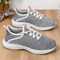 Women's low-top casual sneaker in grey with breathable mesh upper and lace-up front.