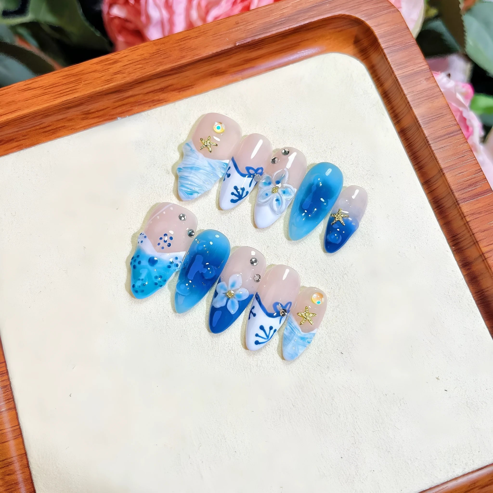 Blue plastic false nails with hand-painted carved summer ice transparent design in four sizes