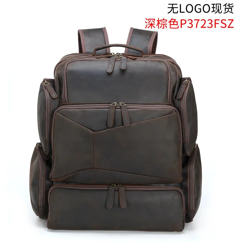 Dark brown retro crazy horse leather backpack for men open to show 17-inch laptop compartment and internal organisers.