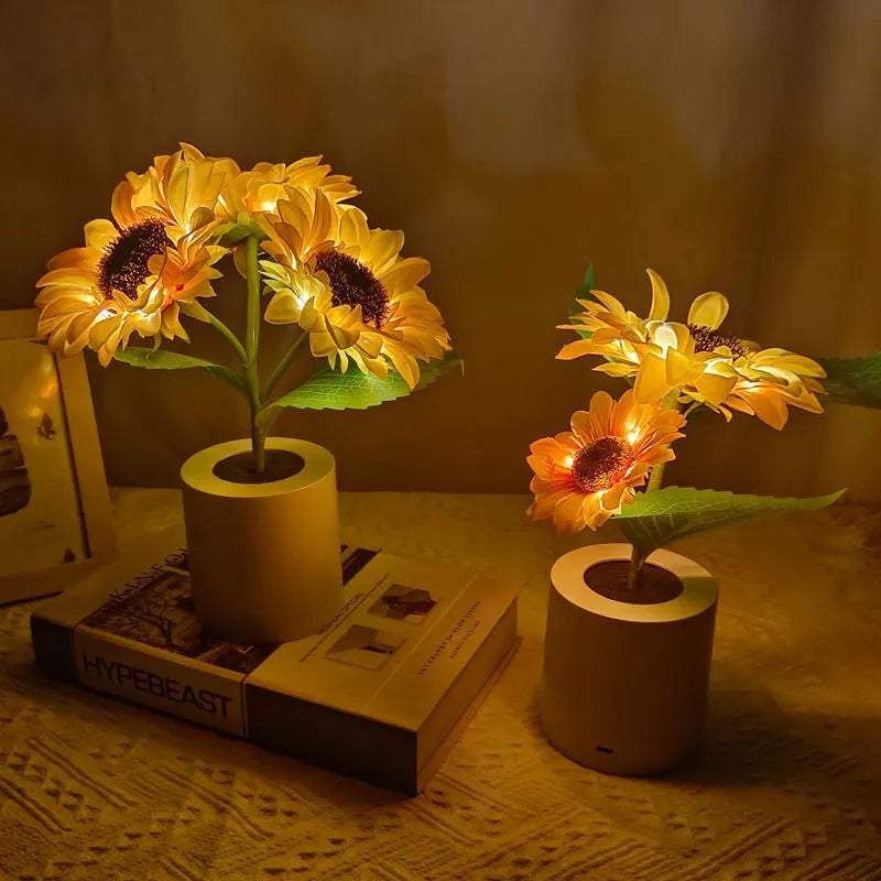 Sunflower LED night light with artificial flowers on wooden table