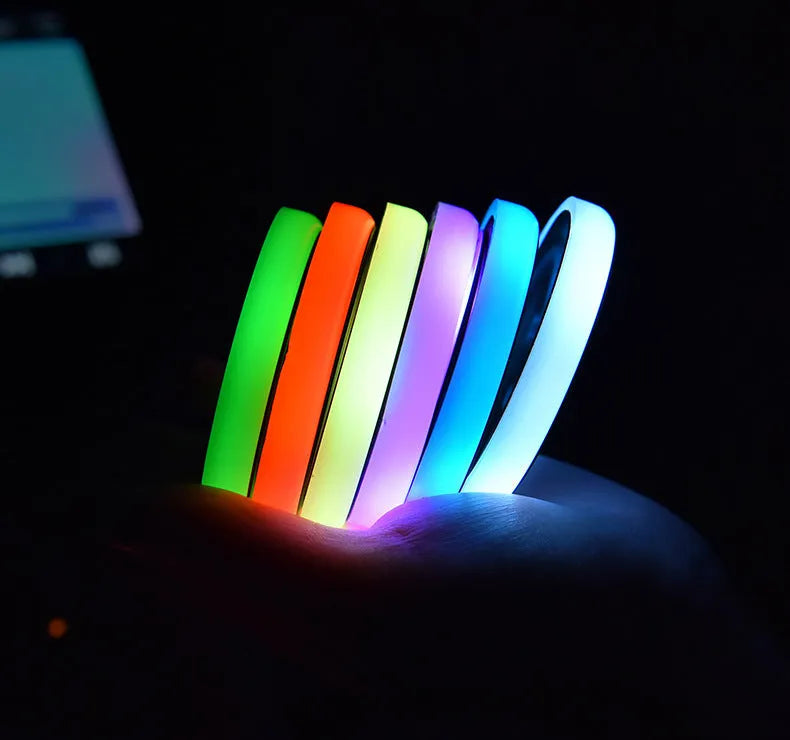 Colourful LED light-up car coaster in a vehicle cup holder, showing multiple light colours.