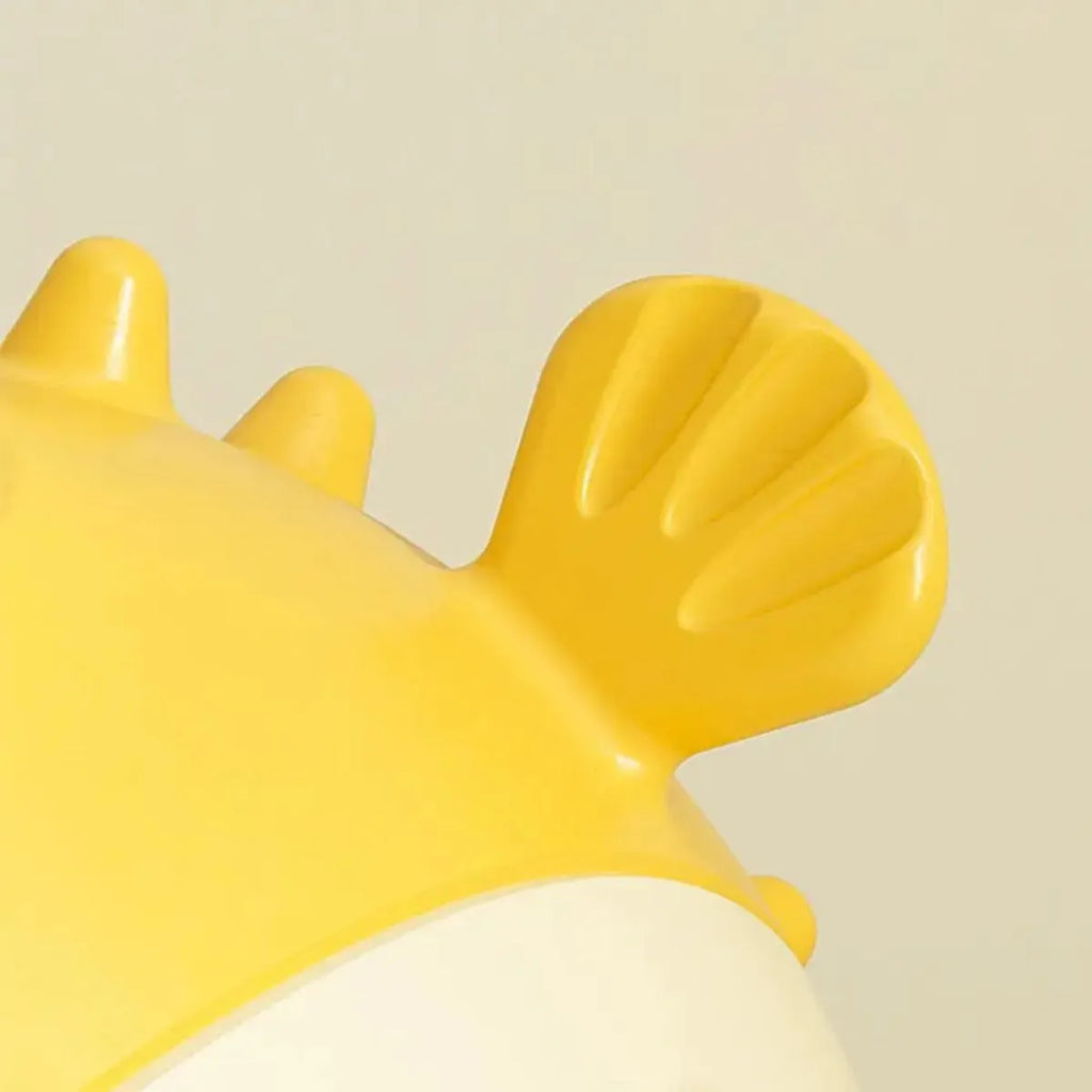 Yellow fish-shaped vinyl dog chew toy with textured surface for aggressive chewers