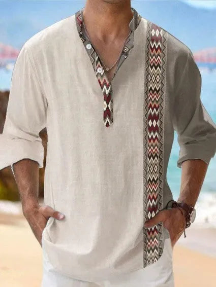 Long sleeve striped Hawaiian shirt in thin polyester fabric on a hanger.