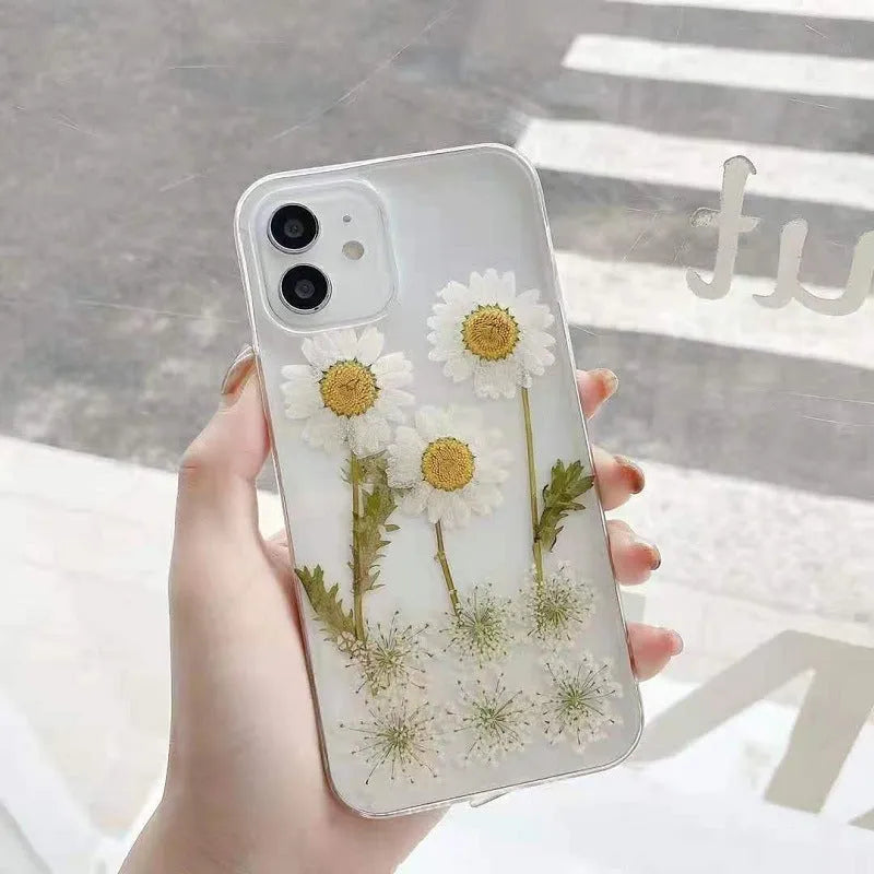 White epoxy daisy floral design on a clear TPU protective phone case for iPhone.